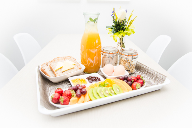 Continental breakfast plate with fruit, juice and bread